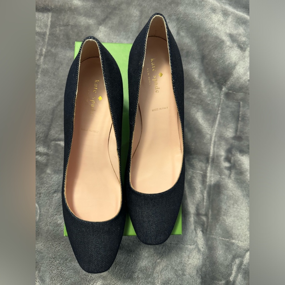 Dark denim Kate Spade pumps with gold accent on the heels.